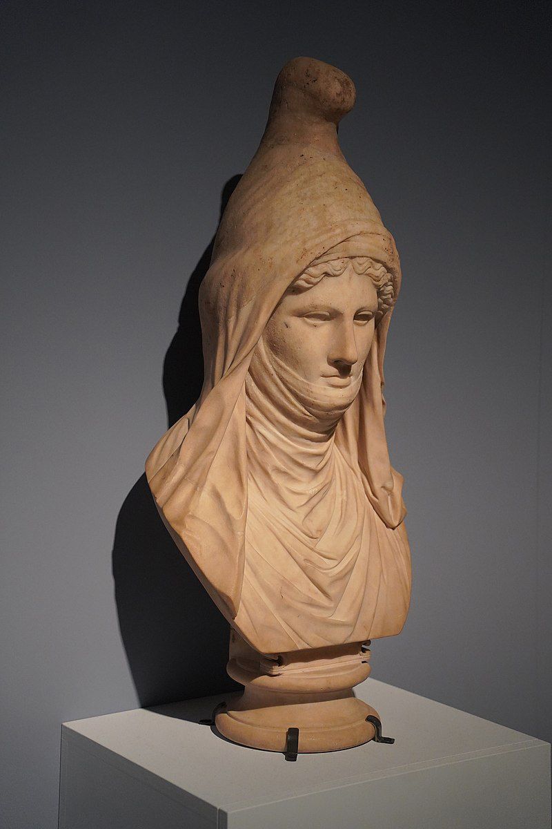 An ancient statue of a woman wearing a Phrygian cap