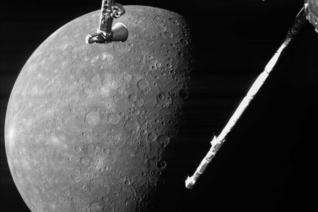 Black and white photo of rocky planet with spacecraft instruments in the foreground