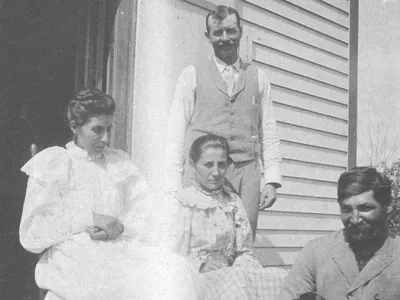 Susan, far left, with her husband (seated with puppy) at their Bancroft, Nebraska, home.