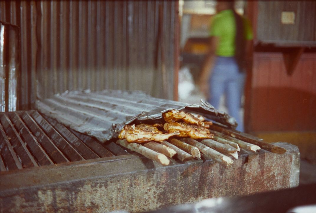Chicken cooking on an open grill