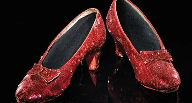 These sequined shoes were worn by 16-year-old Judy Garland as Dorothy in The Wizard of Oz. One of several pairs used during filming, these size-five, felt-soled shoes are well-worn, suggesting they were Garland's primary pair for dancing scenes.