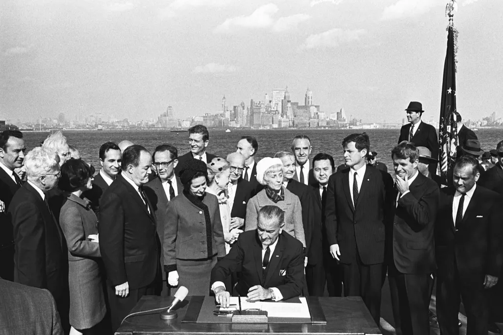 President Lyndon B. Johnson signs the Immigration Bill of 1965 on Liberty Island in New York Harbor.