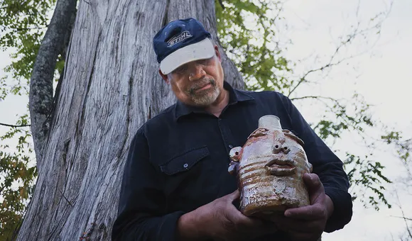 Jim McDowell holds his jug, “Emmett Till.” (Photo By Rimas Zailskas, courtesy of Asheville Made Magazine)