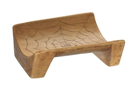 A wooden canoe seat, carved with a spider's web, became noteworthy for being the very first of the 36,000 artifacts in NMAAHC’s collections.
