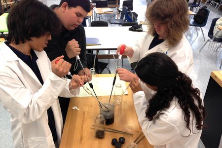 BioTech students prepare a solution for orchids.