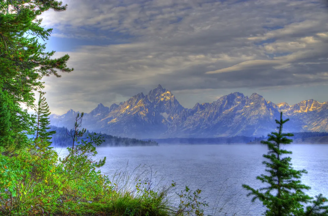 Jackson Lake, Wyoming. Steam rises from the surface of the lake. The
