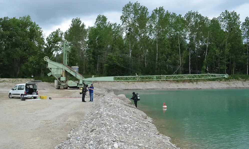 A waterway with a large excavator hovering over top of it