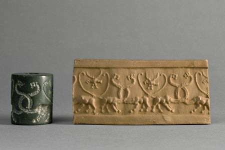 A cylinder seal (left) engraved with symbols that was used to press markings into wet clay (right)
