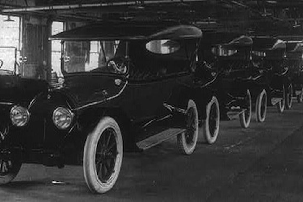 A row of brand new Cadillacs awaits drivers. 1917