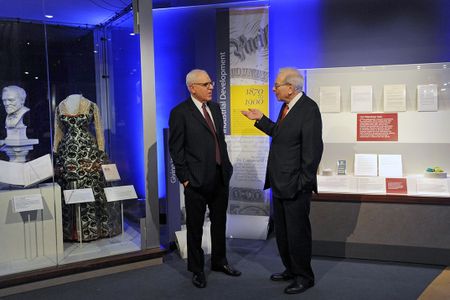 David Rubenstein of The Carlyle Group and Warren Buffett of Berkshire Hathaway preview the “Giving in America" display at the National Museum of American History. 