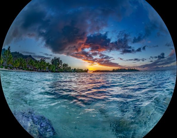 An over/under photo of a sunset on Moorea Island, French Polynesia thumbnail