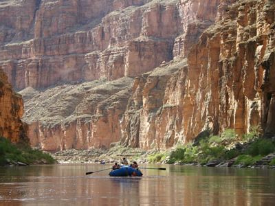 A group of boaters make their way down the peaceful Colorado River in the Grand Canyon.