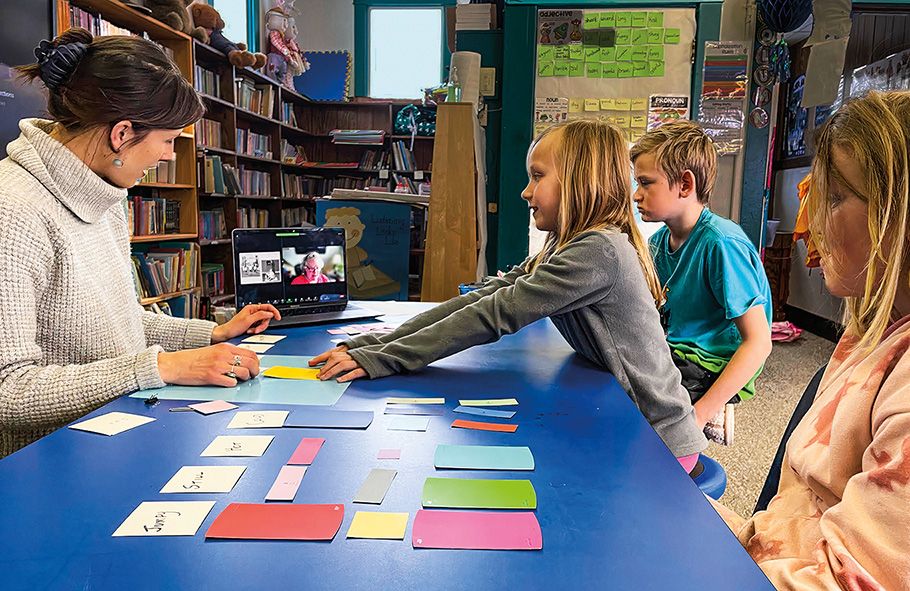 a classroom of students take instructions from their teacher