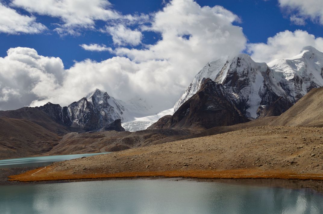 View of Gurudongmar Lake, Sikkim with snow capped peaks in the ...