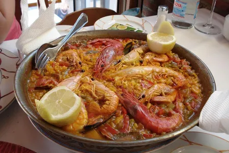 Paella, a national favorite in Spain, is a hearty dish prominently featuring two of Linford's Seven Wonders—rice and tomato. It may be seasoned with salt and chili flakes as well.