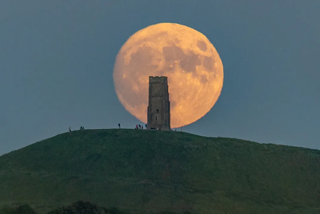 Almost full strawberry moon rises behind Glastonbury Tor, England, June 28, 2026
