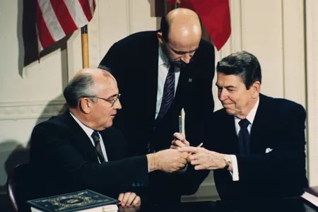 U.S. President Ronald Reagan and Soviet leader Mikhail Gorbachev exchange pens during the signing ceremony for the Intermediate Range Nuclear Forces Treaty in the White House East Room on December 8, 1987. 