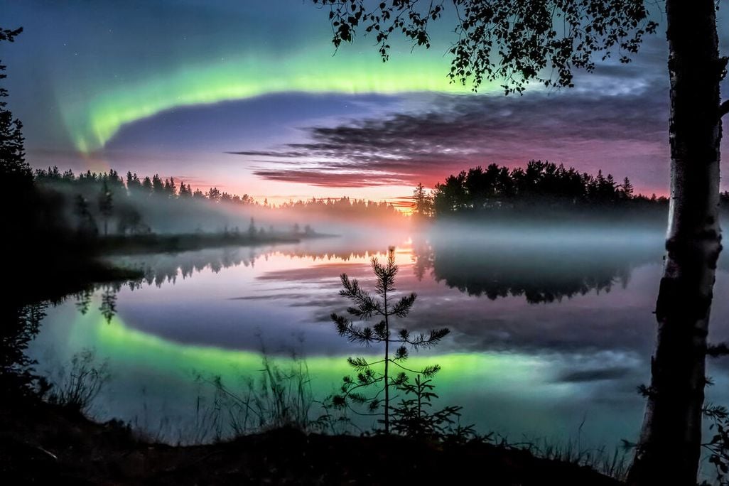 Aurora borealis over body of water