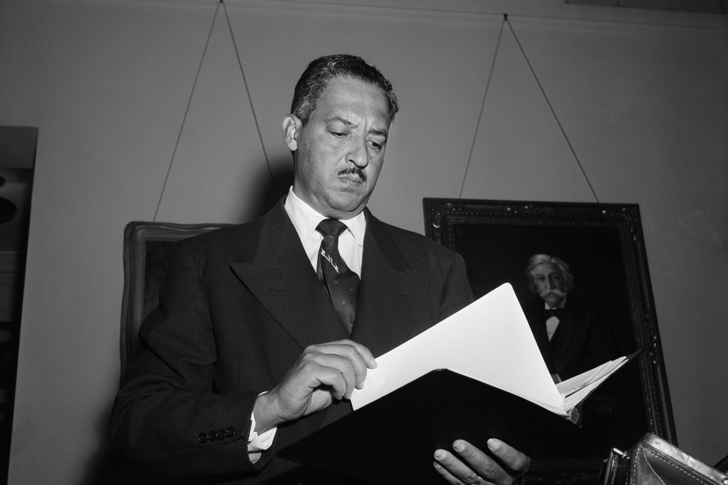 Thurgood Marshall holding book
