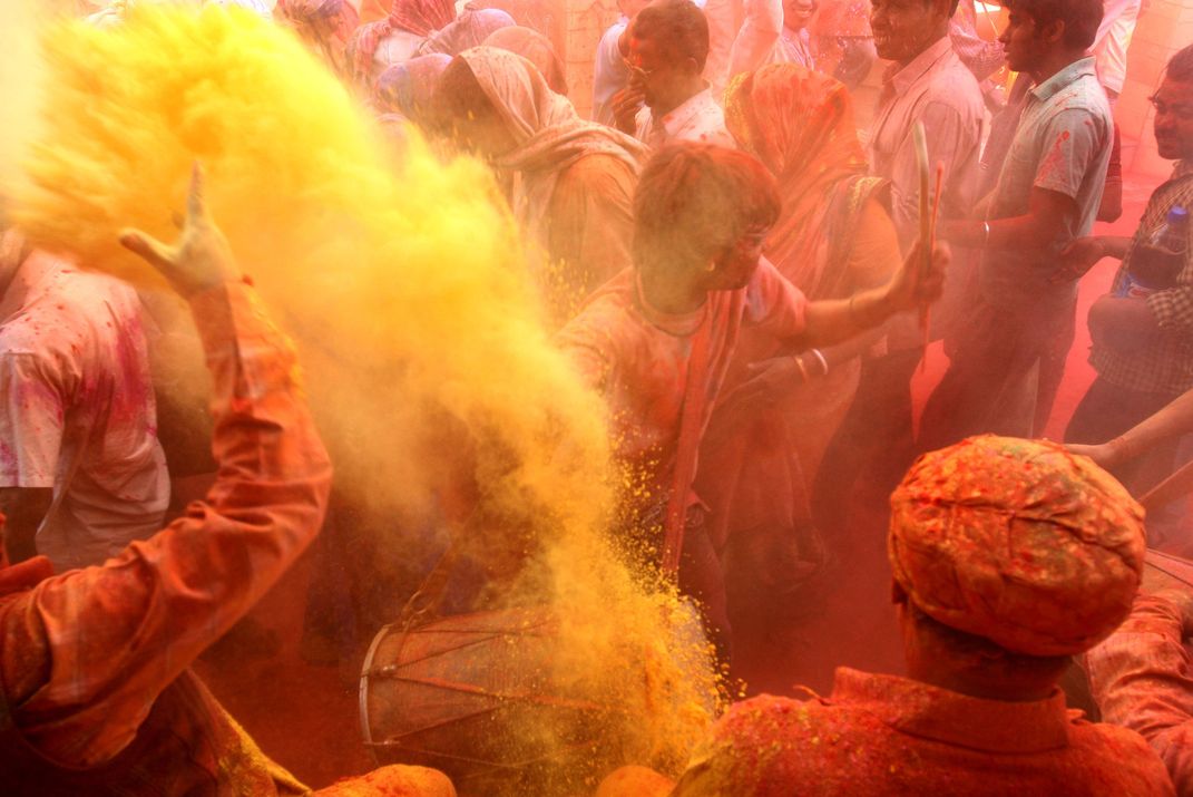 Indians play with color powder during Lath mar Holi at Varsana, 45 km ...