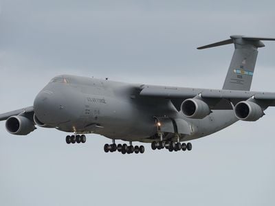 During a 2015 training flight, a C-5M Super Galaxy on final approach prepares to slam 28 tires on the runway at Dover Air Force Base. The freighter is the largest operational aircraft flown by the Air Force.