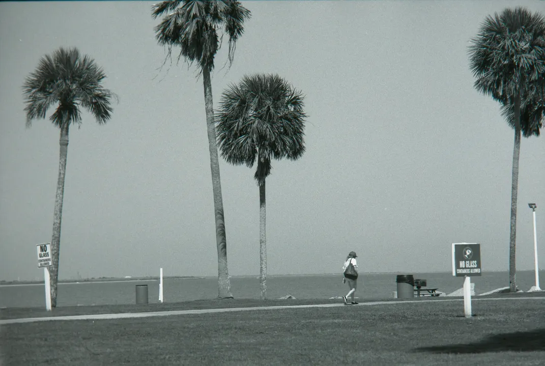 A person walks on a path at Seawolf Park in Galveston, Texas