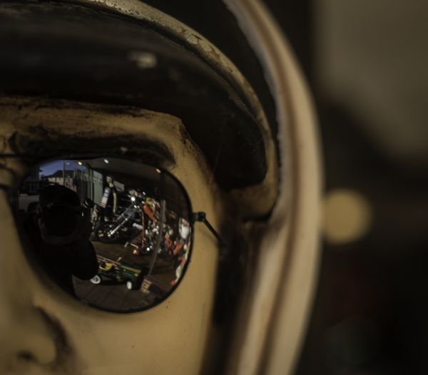 Reflection in aviator sunglasses on a mannequin thumbnail