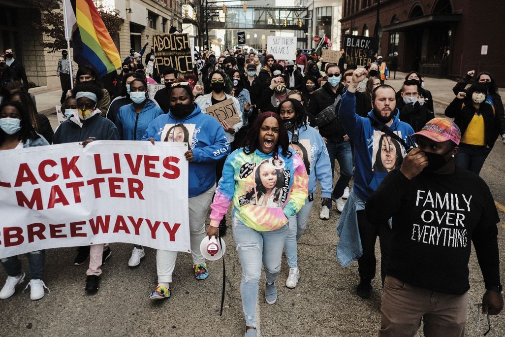 People marching down a street and holding Black Lives Matter signs