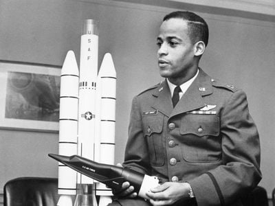 Captain Edward J. Dwight, Jr., the first African American selected as a potential astronaut, looks over a model of Titan rockets in November 1963.