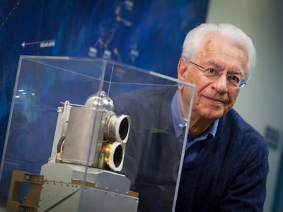 Dr. Tom Krimigis with a flight spare of the Low-Energy Charged Particle detector currently flying on the Voyager 1 and Voyager 2 spacecraft.