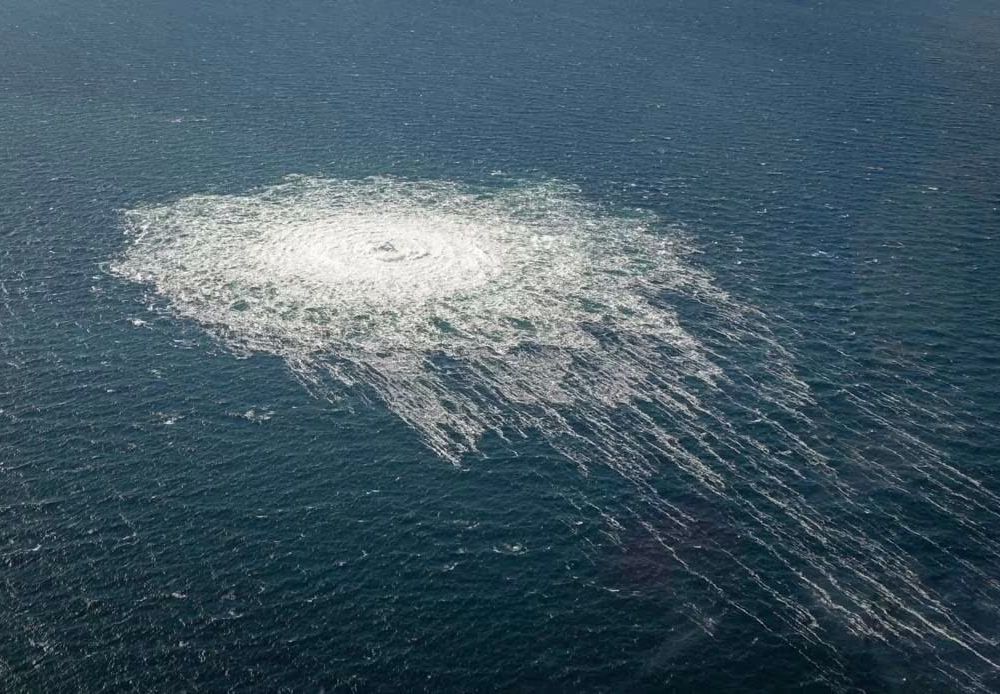 Methane gas bubbles up to the surface of the ocean from burst pipes in the Baltic Sea