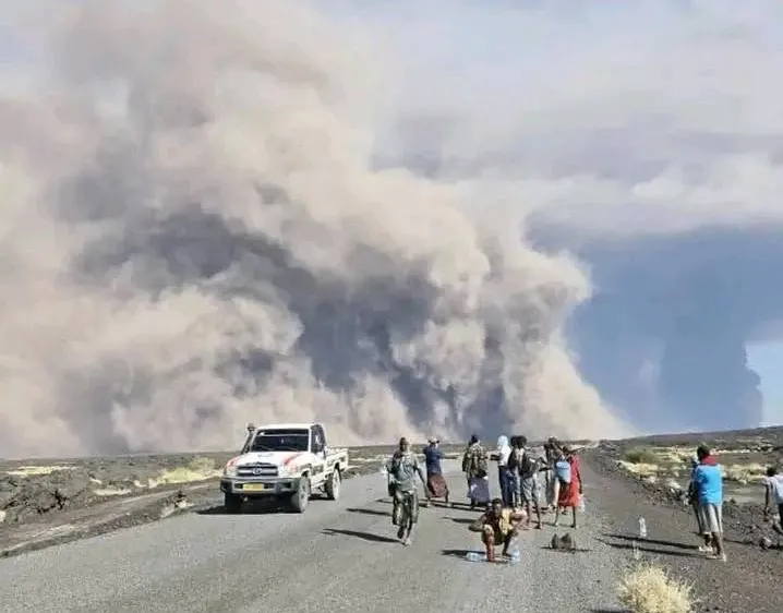 a volcanic plume seen over a road