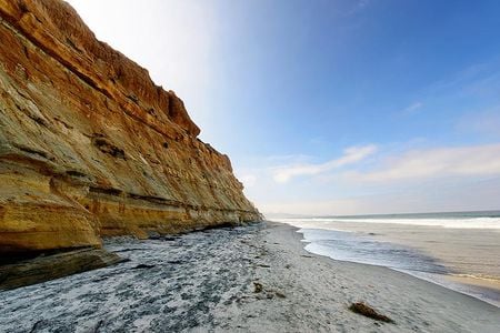 Rain, waves, and seeping groundwater can destabilize seaside bluffs, making them prone to collapse.