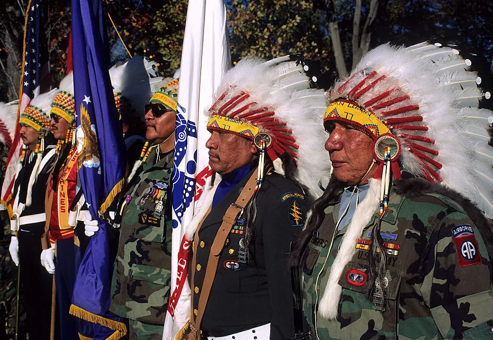 Native American veterans of the Vietnam War stand in honor as part of the color guard at the Vietnam Veterans War Memorial. November 11, 1990, Washington, D.C. (Photo by Mark Reinstein/Corbis via Getty Images)