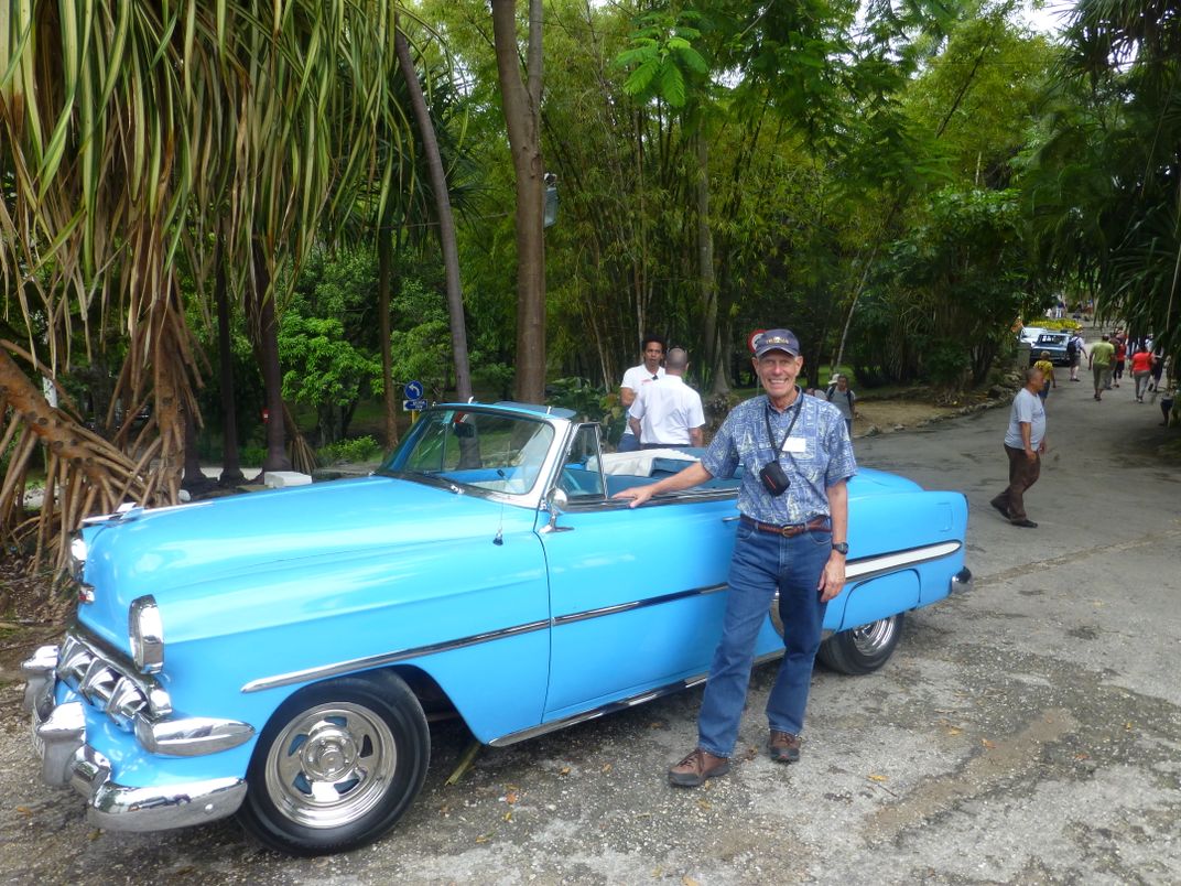 Traveler and Classic Car in Cuba. Credit: John Tindale