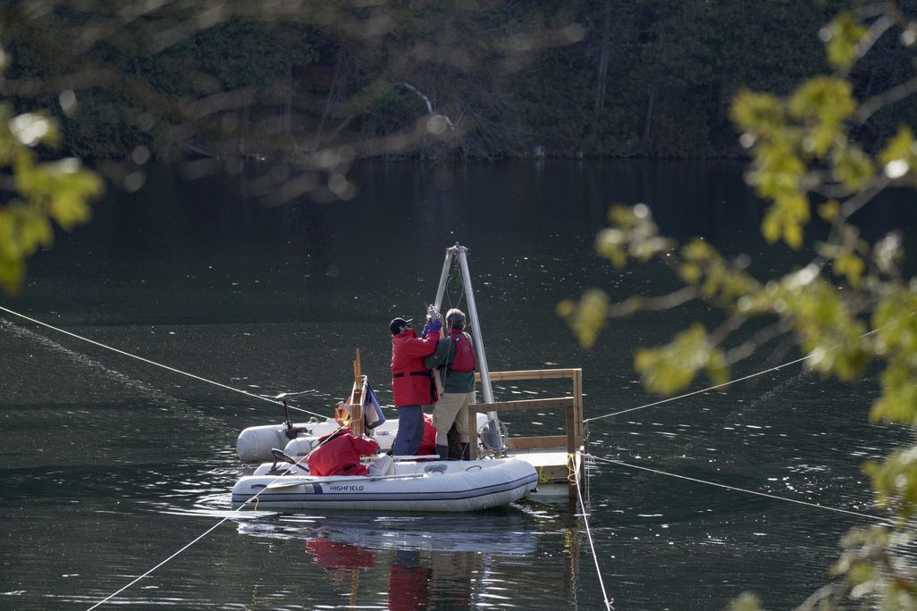 People standing on a raft in water