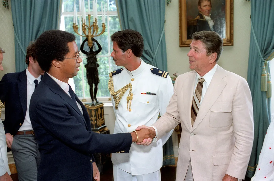 Ashe shakes hands with President Ronald Reagan in 1982.