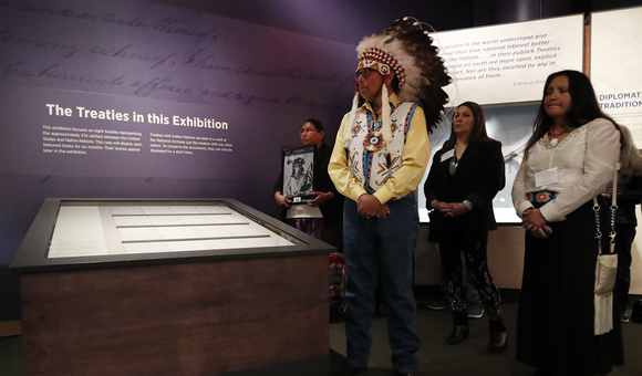 Ramey Growing Thunder (Fort Peck Sioux and Assiniboine Tribes), Chief John Spotted Tail (Rosebud Sioux Tribe), Carolyn Brugh (Fort Peck Sioux and Assiniboine Tribes), and Tamara Stands and Looks Back–Spotted Tail (Rosebud Sioux Tribe) take part in a ceremony at the National Museum of the American Indian honoring the Treaty of Fort Laramie. Ms. Growing Thunder holds a photograph of Medicine Bear (Yanktonai Band of Sioux), one of the Native leaders who signed the treaty 150 years ago. Delegations from the Yankton Sioux Tribe, Oglala Sioux Tribe, and Northern Arapaho Tribe also traveled to Washington, D.C., for the installation of the treaty in the exhibition 