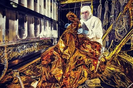 NASA is mostly closed for business, including posting any new photos for the public, so we're glad we bookmarked this photo bookmarked this photo posted by the center at Goddard a couple weeks ago. This rabbit-suited-up engineer is preparing thermal blankets for the James Webb Space Telescope to be tested in a vacuum chamber. As described on the Instagram post: 

Those blankets are made of aluminized kapton, a polymer film that remains stable over a wide range of temperatures. Just as blankets insulate people from cold, these golden-colored thermal blankets help prevent heat from seeping into the vacuum chamber that will drop temperatures to mimic those of deep space.

Photo: NASA Goddard / Chris Gunn