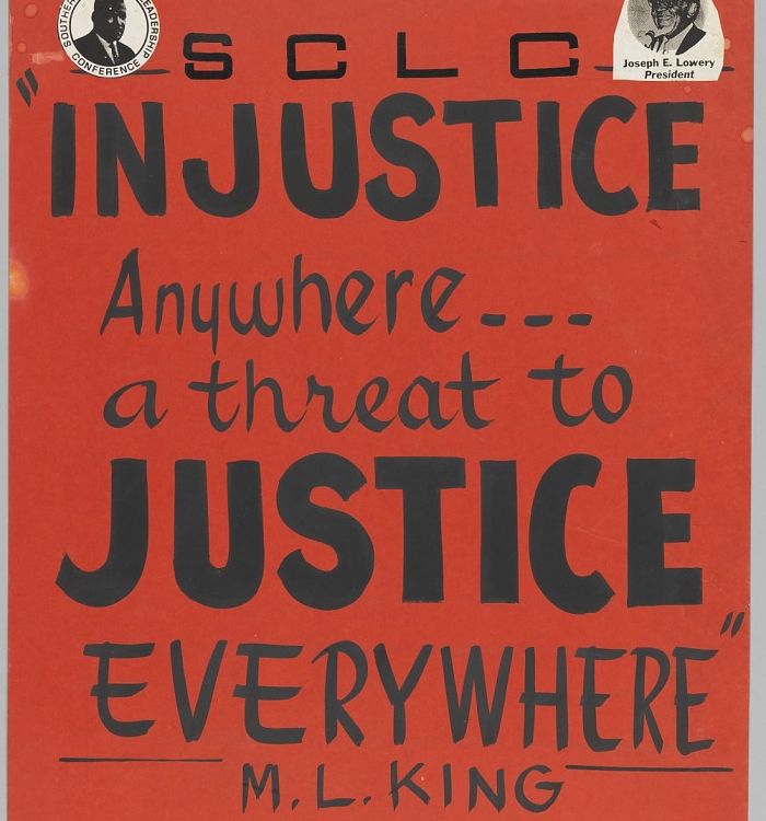 A black ink on a red-orange poster board with a small picture of Martin Luther King, Jr. at the top left and Joseph Lowery at the top right. The poster reads: [SCLC / INJUSTICE / Anywhere... / a threat to / JUSTICE / EVERYWHERE / M. L. KING].