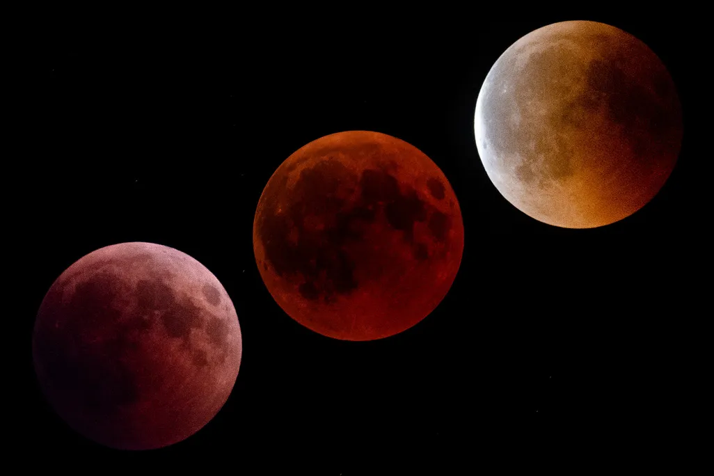 three phases of a lunar eclipse, with a blood-red moon seen in the middle