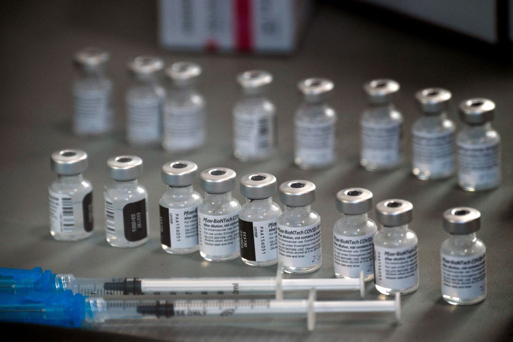 A photo of Pfizer vaccine vials and syringes 