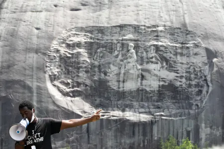 Organizer Quintavious Rhodes addresses Black Lives Matter protesters during a march in Stone Mountain Park on June 16, 2020. Activists have long called for Stone Mountain's carved relief of Confederate generals to be taken down. 