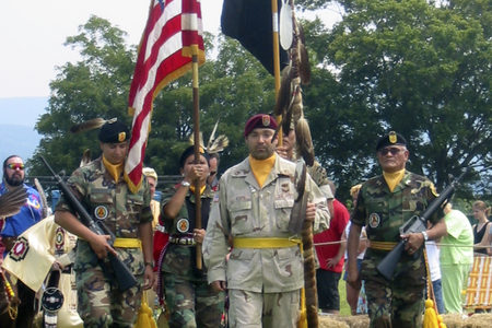 On mid-tour leave from Operation Iraqi Freedom, Sergeant First Class Chuck Boers carries in the eagle staff at the Shenandoah Powwow, 2004. (Courtesy of Chuck Boers)
