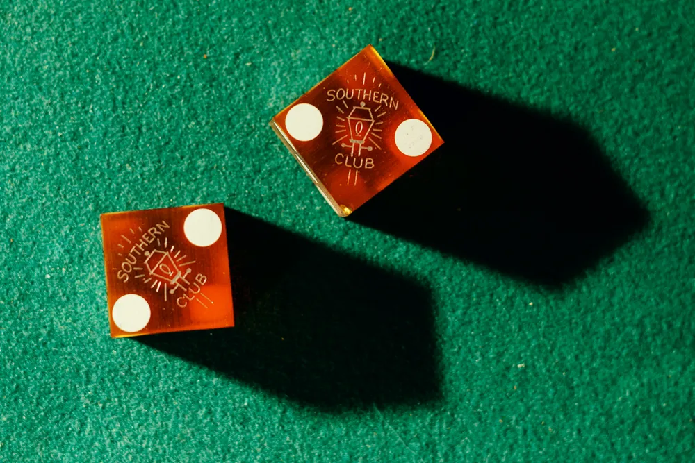dice sitting on a green surface
