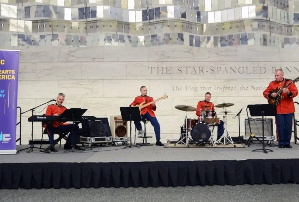 Four U.S. Marine band members perform on stage inside the museum
