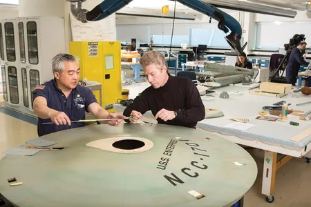 The model arrived at the Smithsonian in 1974 lacking most of its lights, and replacements burned hot and gave off damaging ultraviolet light. Specialists Will Lee (left) and David Wilson work on ways to deploy new LEDs, which give off little heat and no UV light.