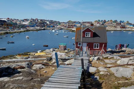 Ships float in Aasiaat&rsquo;s harbor.