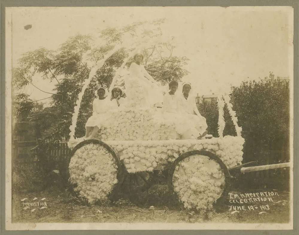 Black women sitting on a decorated carriage during a Juneteenth celebration in Texas in 1913