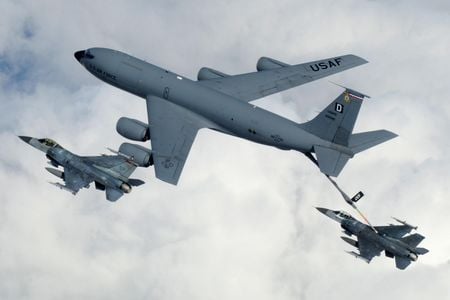 A KC-135 Stratotanker from Royal Air Force Mildenhall, England, refuels a pair of F-16 Fighting Falcons in flight.